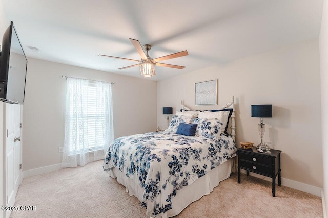 bedroom featuring multiple windows, light carpet, and ceiling fan