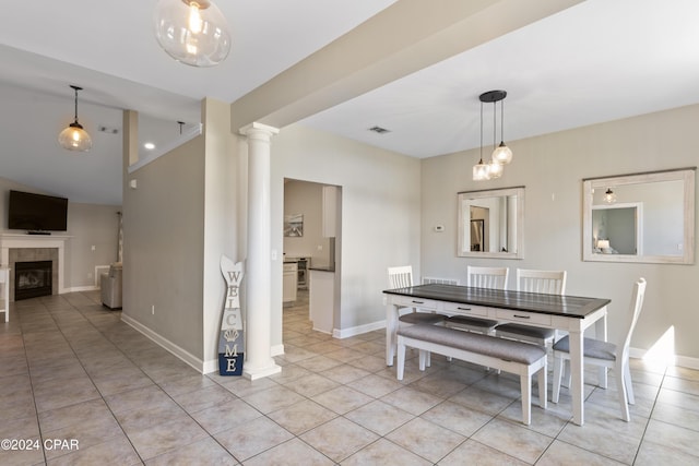 tiled dining space with a tile fireplace