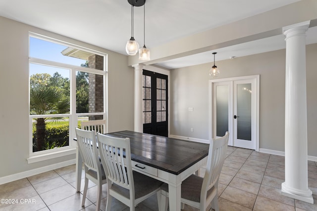 tiled dining room featuring french doors, decorative columns, and a wealth of natural light