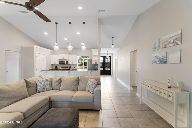 living room with ceiling fan, light tile patterned floors, and high vaulted ceiling