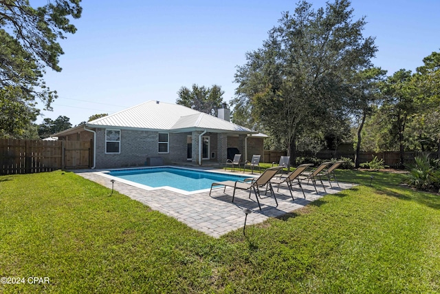 view of swimming pool featuring a yard and a patio