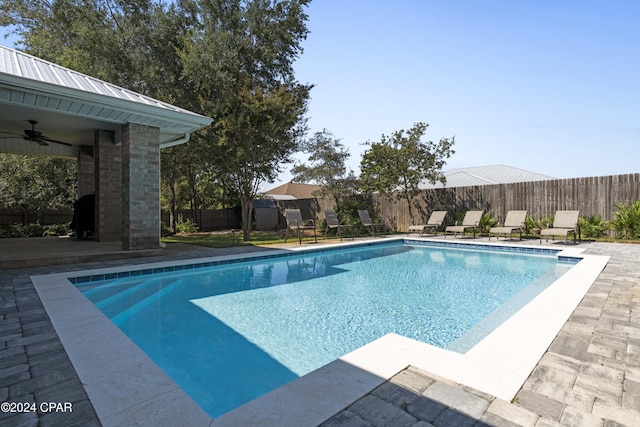 view of pool featuring ceiling fan and a patio