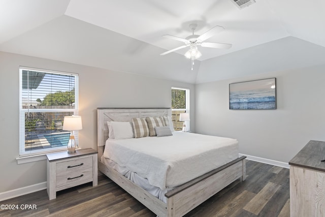 bedroom featuring ceiling fan, dark hardwood / wood-style floors, lofted ceiling, and multiple windows