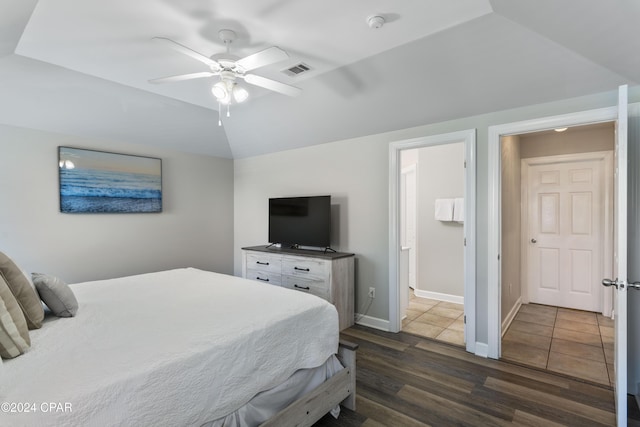 bedroom featuring lofted ceiling, ensuite bath, ceiling fan, and dark hardwood / wood-style floors