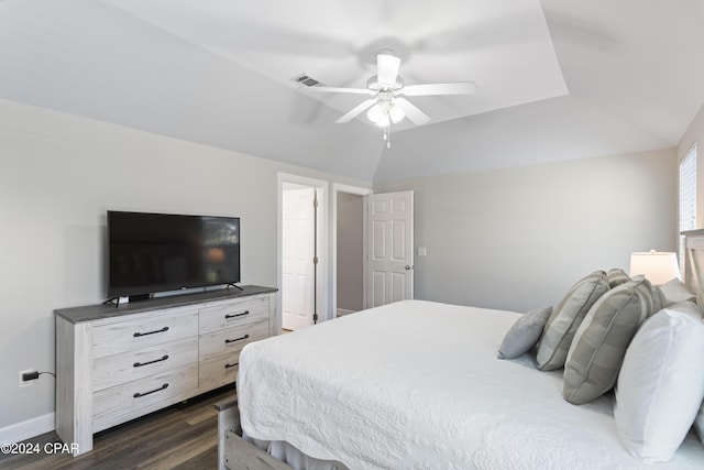 bedroom featuring dark hardwood / wood-style flooring, vaulted ceiling, and ceiling fan