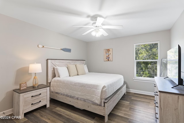 bedroom featuring ceiling fan and dark hardwood / wood-style floors