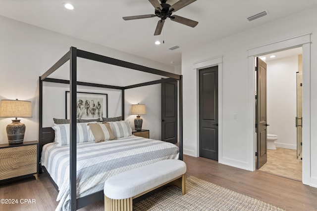 bedroom with hardwood / wood-style flooring, ceiling fan, and ensuite bathroom