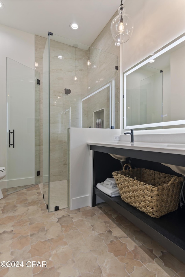 bathroom with vanity, toilet, and a shower with shower door