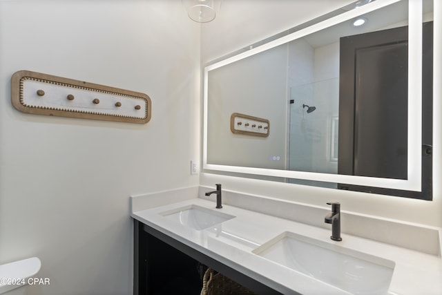 bathroom featuring vanity, toilet, and tiled shower