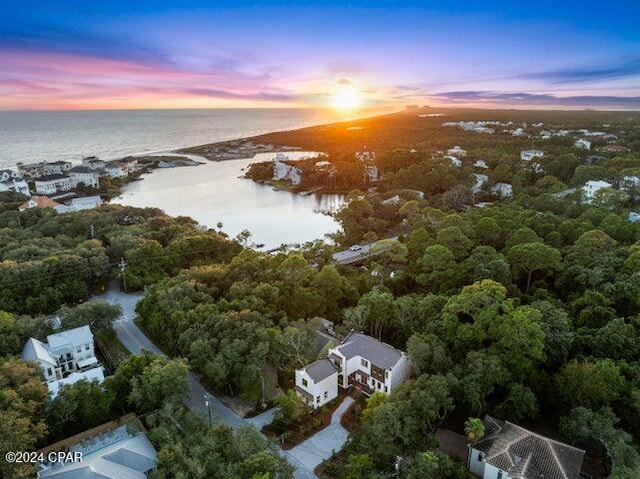 aerial view at dusk featuring a water view