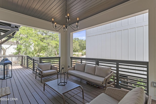 wooden terrace with an outdoor living space