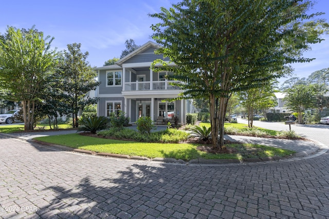 view of front of home with a balcony and covered porch