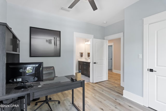 office with ceiling fan, light wood-type flooring, and sink