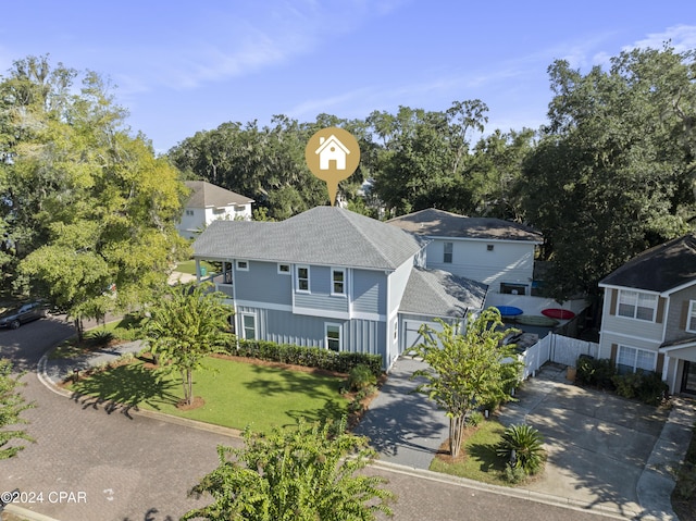 exterior space featuring a garage and a front lawn