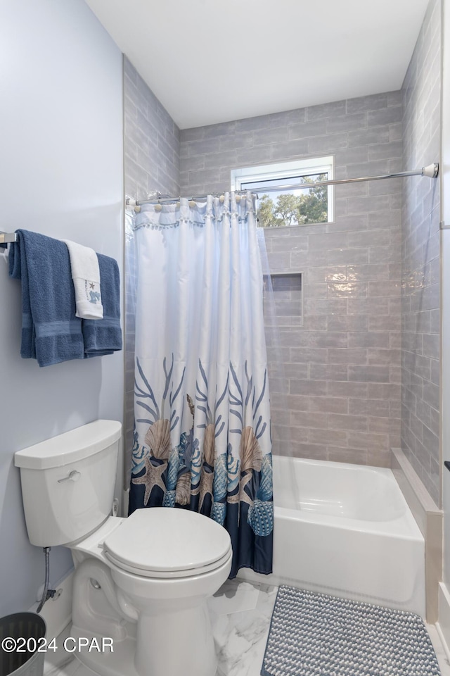 bathroom featuring toilet and shower / tub combo