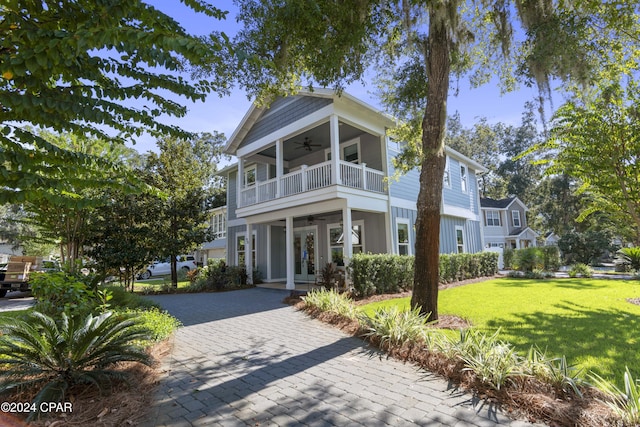 greek revival inspired property with ceiling fan, a balcony, french doors, and a front yard