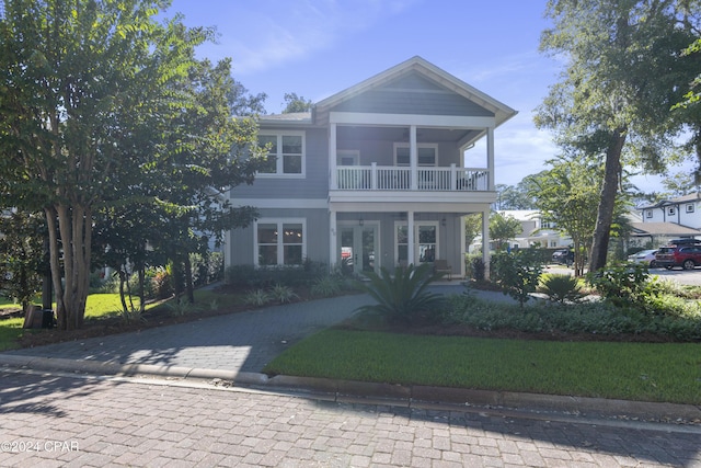 view of front of property with covered porch and a balcony