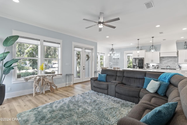 living room with ceiling fan, light hardwood / wood-style floors, and ornamental molding