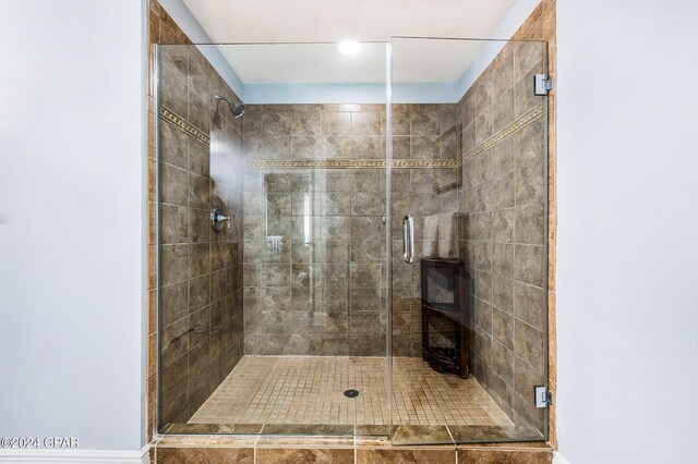 bathroom featuring a shower with door