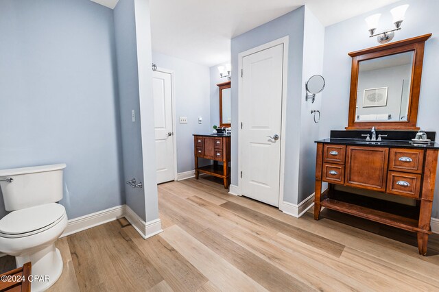 bathroom featuring hardwood / wood-style flooring, vanity, and toilet