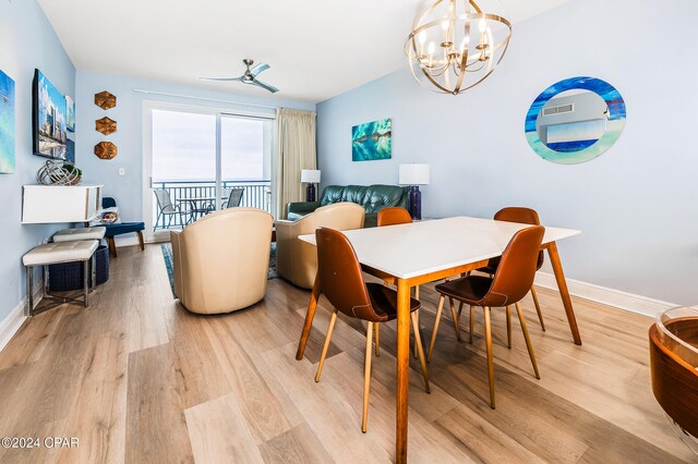 dining room featuring ceiling fan with notable chandelier and light wood-type flooring