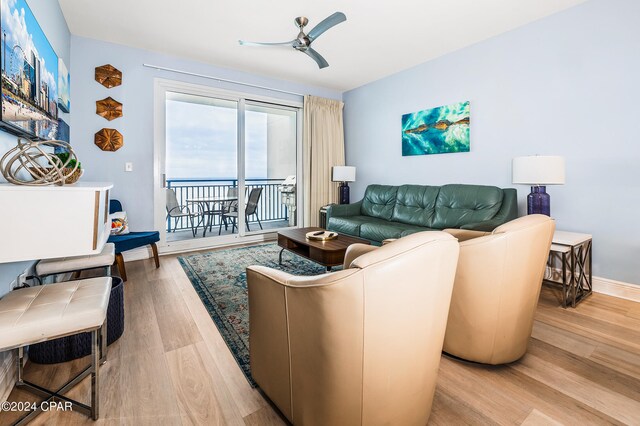 living room featuring ceiling fan and light hardwood / wood-style flooring