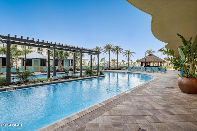 view of swimming pool featuring a pergola and a patio