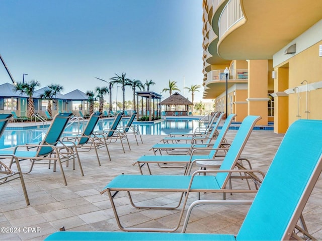 patio terrace at dusk with a community pool