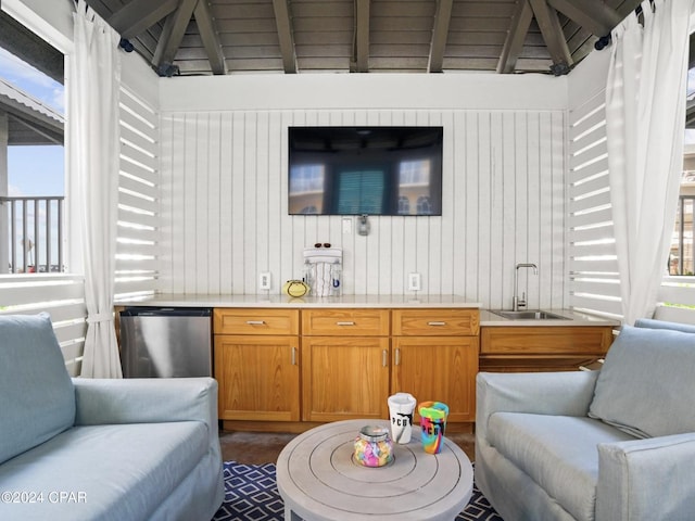 bar featuring sink, refrigerator, and lofted ceiling