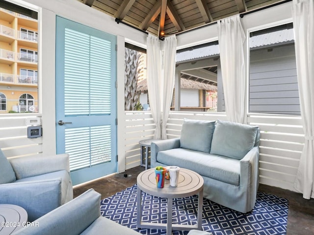 sunroom featuring beamed ceiling and wood ceiling