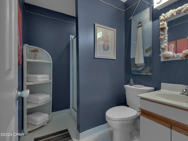 bathroom featuring tile patterned floors, vanity, an enclosed shower, and toilet