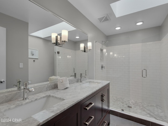 bathroom featuring a skylight, vanity, an enclosed shower, and an inviting chandelier