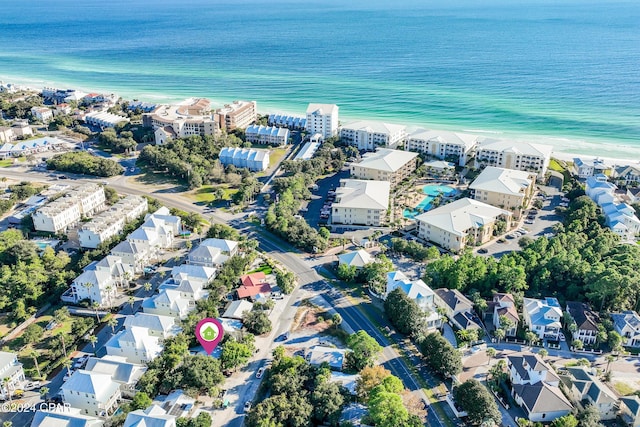 aerial view with a water view and a beach view