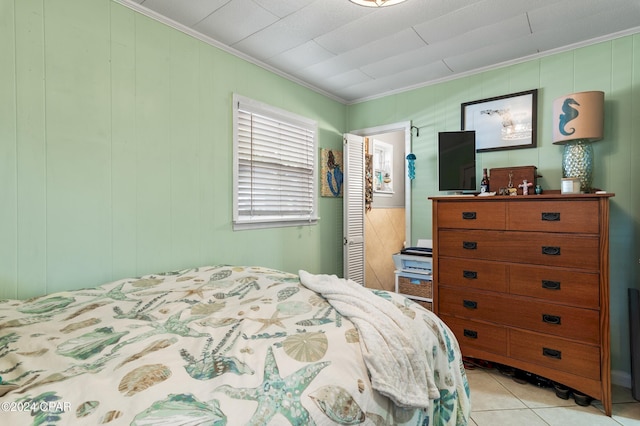 tiled bedroom with crown molding and wood walls