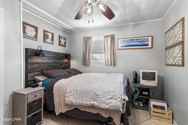 bedroom featuring ceiling fan, ornamental molding, and light tile patterned flooring