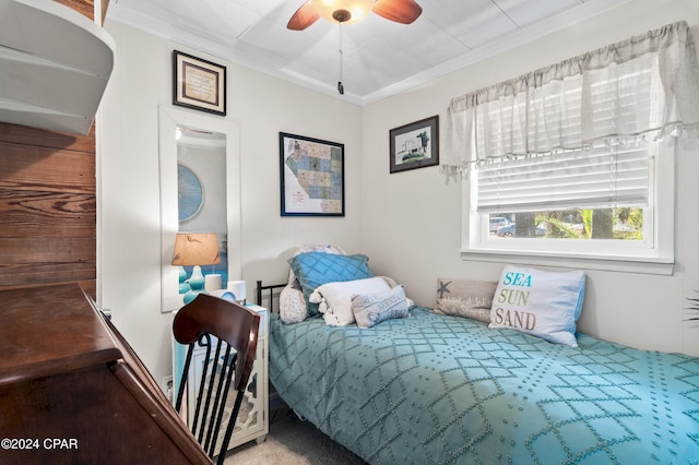 bedroom with ceiling fan and crown molding