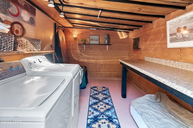 laundry area with wooden ceiling, wooden walls, and washing machine and clothes dryer