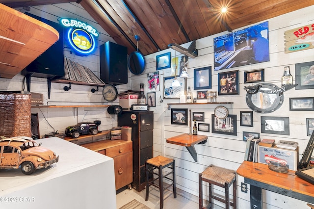 kitchen featuring vaulted ceiling, wooden walls, and wood ceiling