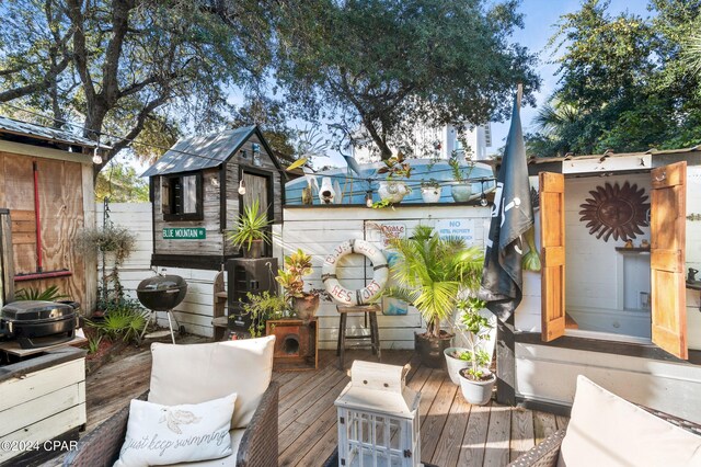 wooden terrace featuring grilling area