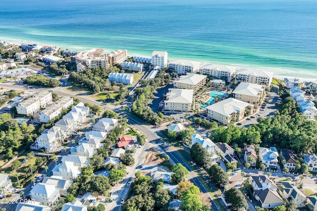 drone / aerial view with a water view and a beach view