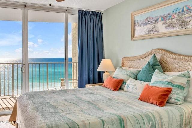 bedroom with access to outside and a water view