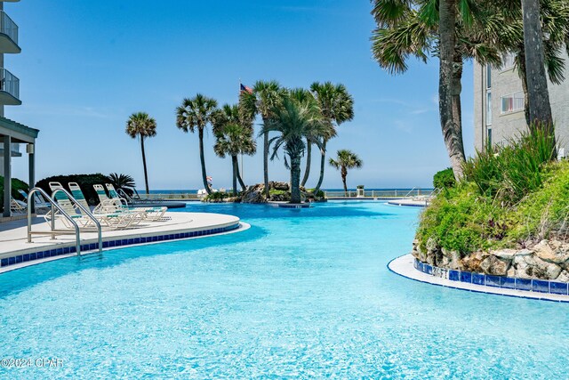 view of swimming pool with a water view