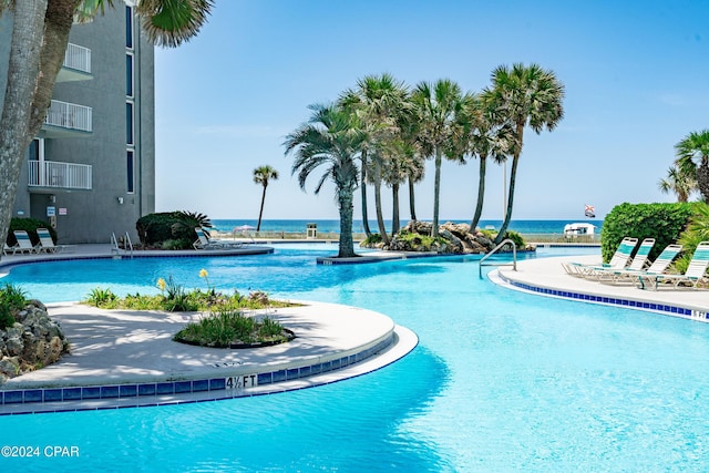 view of pool with a water view