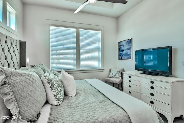 bedroom featuring ceiling fan and multiple windows