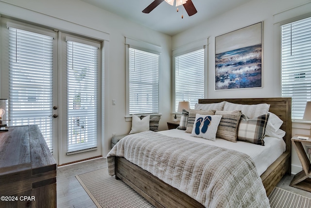 bedroom with ceiling fan, hardwood / wood-style floors, and access to outside