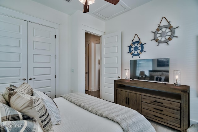 bedroom featuring ceiling fan, a closet, and hardwood / wood-style flooring