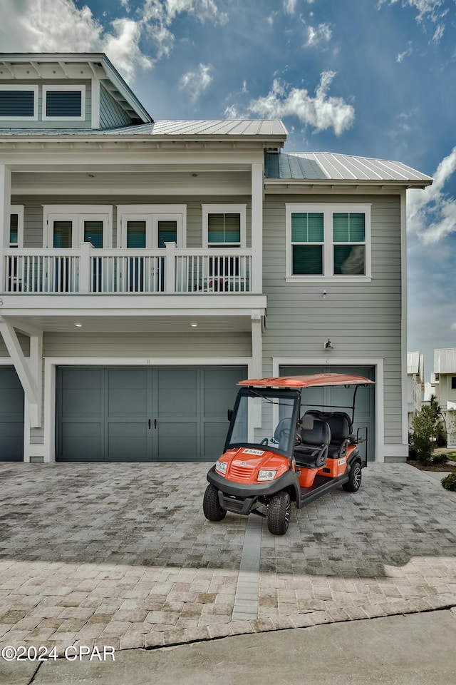 view of front of house with a garage and a balcony