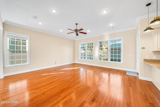 unfurnished living room featuring ornamental molding, ceiling fan, and light hardwood / wood-style floors