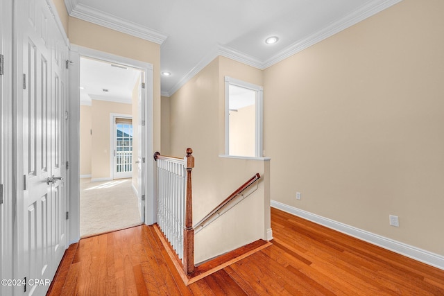 corridor featuring ornamental molding and hardwood / wood-style floors