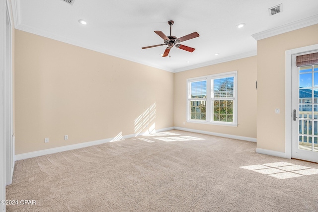 carpeted spare room featuring ornamental molding and ceiling fan